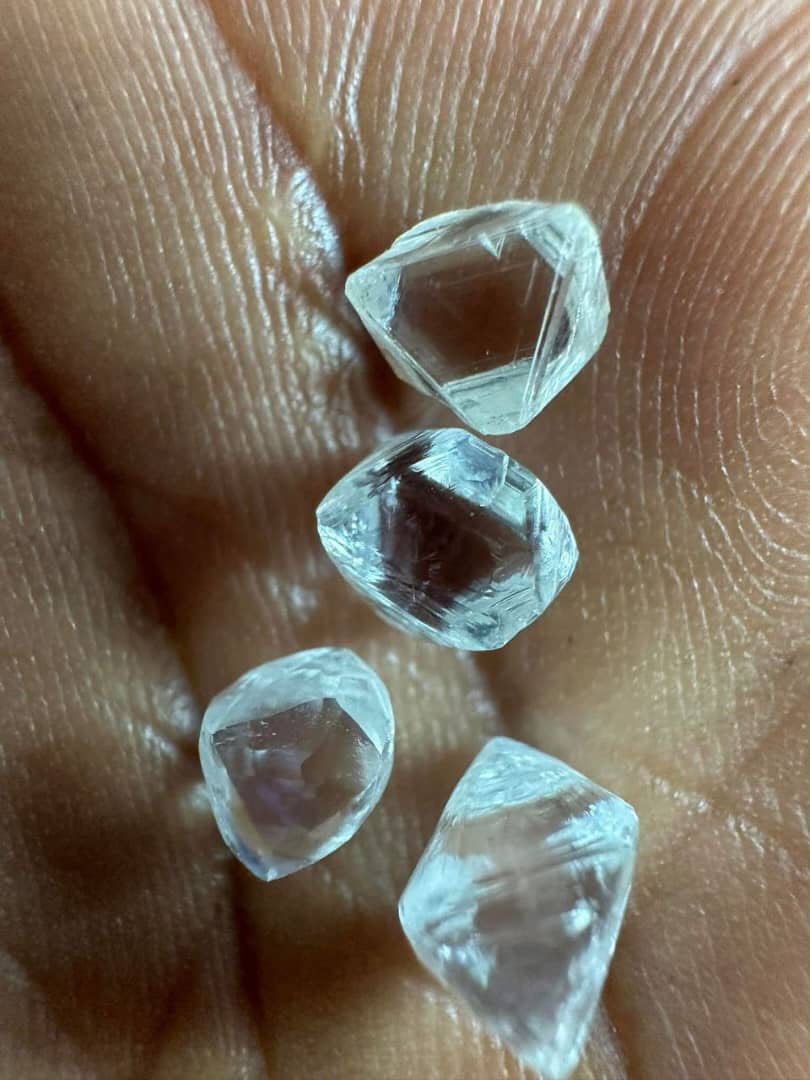Close-up of rough diamonds on a palm